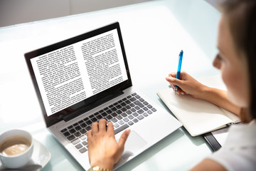 Businesswoman Reading Information On Laptop