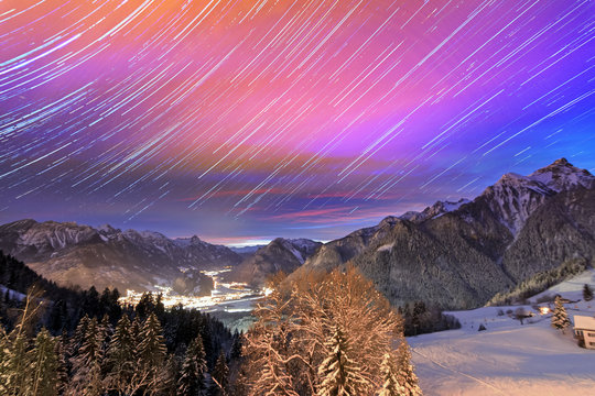 Beautiful stacked timelapse of stars at night until sunrise over the Brandnertal in the mountains of the Alps in Vorarlberg, Austria