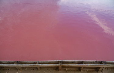 Pink salt pool edge in saltmine, top view background texture