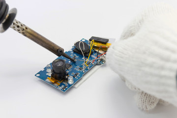 technician repairing electronic of the circuit board by soldering Irons, concept  technology of circuit hardware