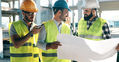 Portrait of construction engineers working on building site