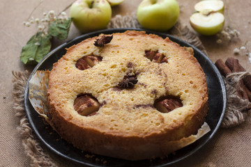 Apple cinnamon cake, cinnamon sticks, apples on the table