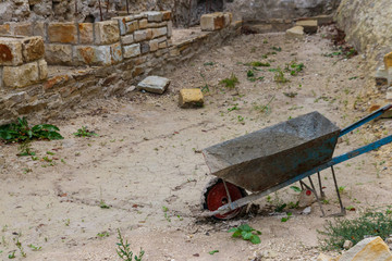 Wheelbarrow or trolley in construction site. Construction industry concept