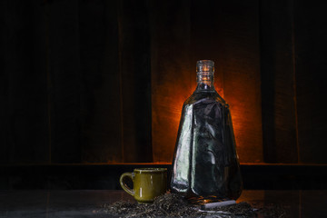 whisky and tobacco in the bar / on the old wooden table which has Whiskey in glass and bottle / selective focus and copy space / Vintage Style