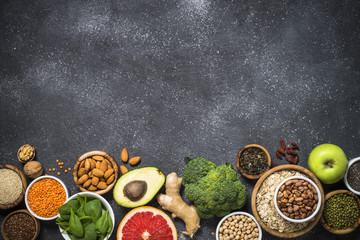 Superfoods on black stone background. 