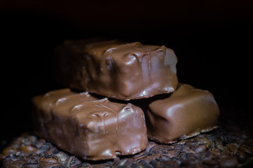 Three chocolate bars on a dark background