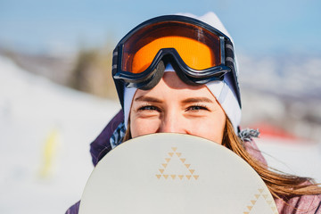 a young woman looks out of the snowboard