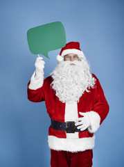 Santa claus holding speech bubble at studio shot