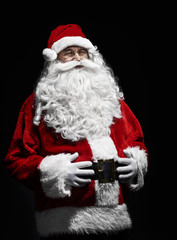 Portrait of cheerful santa claus with hands on stomach