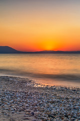 Fototapeta premium Early morning , dramatic sunrise over sea and mountain. Photographed in Asprovalta, Greece.