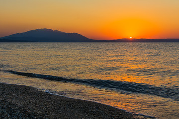 Fototapeta premium Early morning , dramatic sunrise over sea and mountain. Photographed in Asprovalta, Greece.