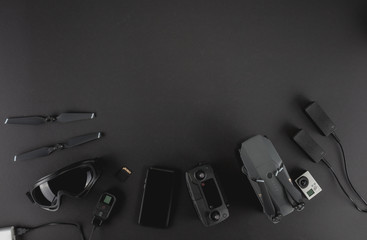 Work space professional photographer flight kit on quadcopter with VR glasses. Top view on black...
