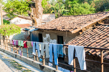 Fototapeta na wymiar Laundry drying at a railing in Suchitoto, El Salvador
