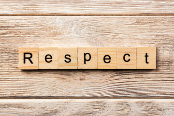 respect word written on wood block. respect text on table, concept
