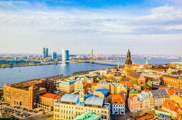 Panoramic view of old town with bright colorful houses and Riga Dome Cathedral, bridge over Dvina river in Riga, Latvia. Beautiful cityscape, top view. - obrazy, fototapety, plakaty