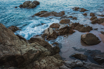 Blue Mediterranean Sea foaming on the rocks near the coast, Spain