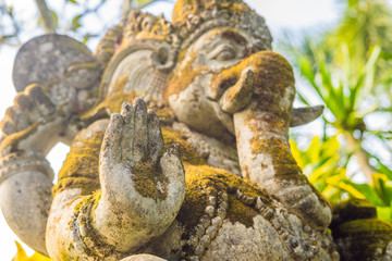 Ganesha coverd by moss in the park