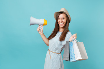 Portrait woman in summer dress, hat holding packages bags with purchases after shopping, scream in...