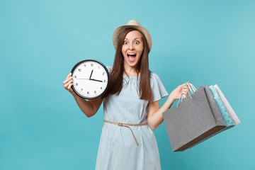 Portrait beautiful young caucasian woman in summer dress, straw hat holding packages bags with...