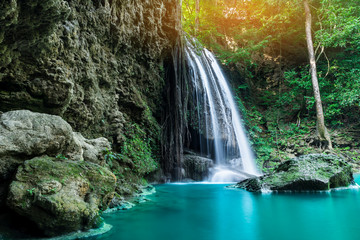 Fototapeta na wymiar Erawan waterfall in tropical forest of national park, Thailand 