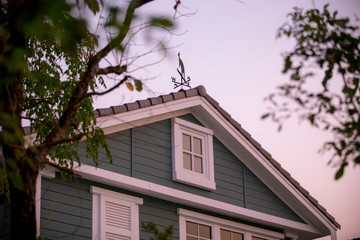 the roof of the house with nice window / English style house, show the window under the roof