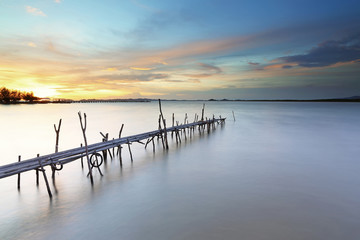 Bamboo pier bridge at beautiful sunset. soft focus due to long exposure