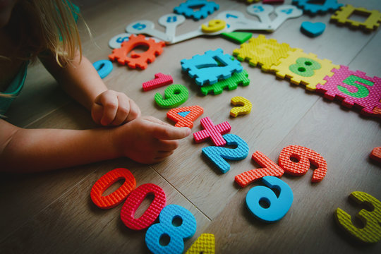little girl learning numbers and math, play with puzzle