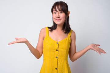 Portrait of beautiful Asian woman wearing yellow dress