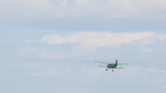 Old biplane plane flies in the sky