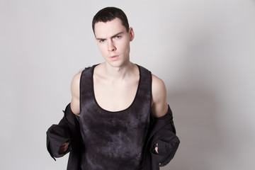 Beautiful strong face male model in fashion cloathes on white isolated font background