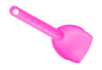 Small plastic toy shovel isolated on a white background.