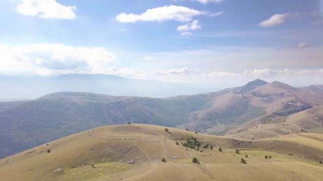AERIAL: drone flying over the mountains near to the Gran Sasso mountain, Abruzzo, Italy, in a sunny day.