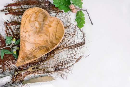 Empty wooden bowl handmade from olive tree, in the shape of a heart. Copy space