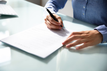 Businesswoman's Hand Signing Contract