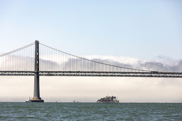 The San Francisco Bay Bridge with Alcatraz in the distance