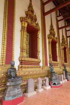 Buddha statues and ornate wall at the Wat Haw Phra Kaew (Haw Pha Kaew, Hor Pha Keo, Ho Prakeo), a former temple in Vientiane, Laos, first built in 1565. 