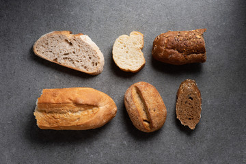 flat lay with pieces of various bread on grey tabletop
