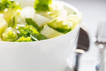 green salad in a white bowl. concept of healthy life