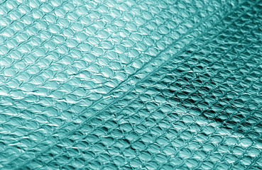 Shiny metal surface in cyan tone.