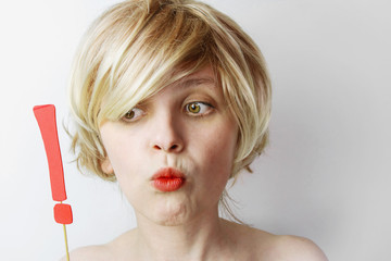 Young woman holding an exclamation mark