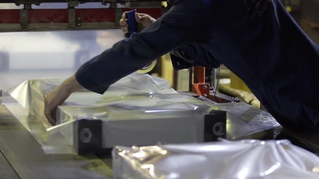 Worker Packaging of heating radiators in factory