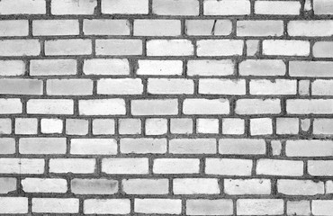 Grungy weahered brick wall in black and white.