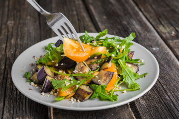 Warm salad with fried eggplant, arugula, cherry tomatoes,