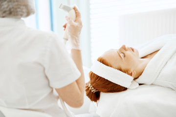 Skin Care Concept. Beautician hand with RF lifting medicine device boosting skin turgor to gorgeous...