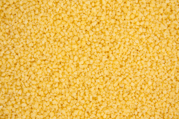 Background texture of couscous grains. Close up. Top view.