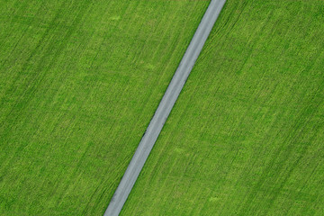 Empty Street with ariel view green meadow field close-up