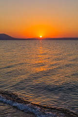 Fototapeta premium Early morning , dramatic sunrise over sea and mountain. Photographed in Asprovalta, Greece.