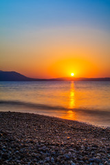 Fototapeta premium Early morning , dramatic sunrise over sea and mountain. Photographed in Asprovalta, Greece.