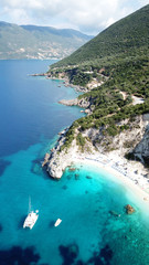 Obraz premium Aerial drone photo of iconic paradise sandy beach of Agiofili near port of Vasiliki with emerald crystal clear sea and sail boats docked, Lefkada island, Ionian, Greece