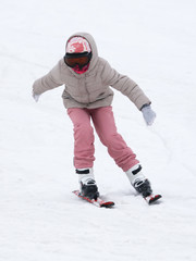 Fototapeta na wymiar Girl skiing from the mountain in winter